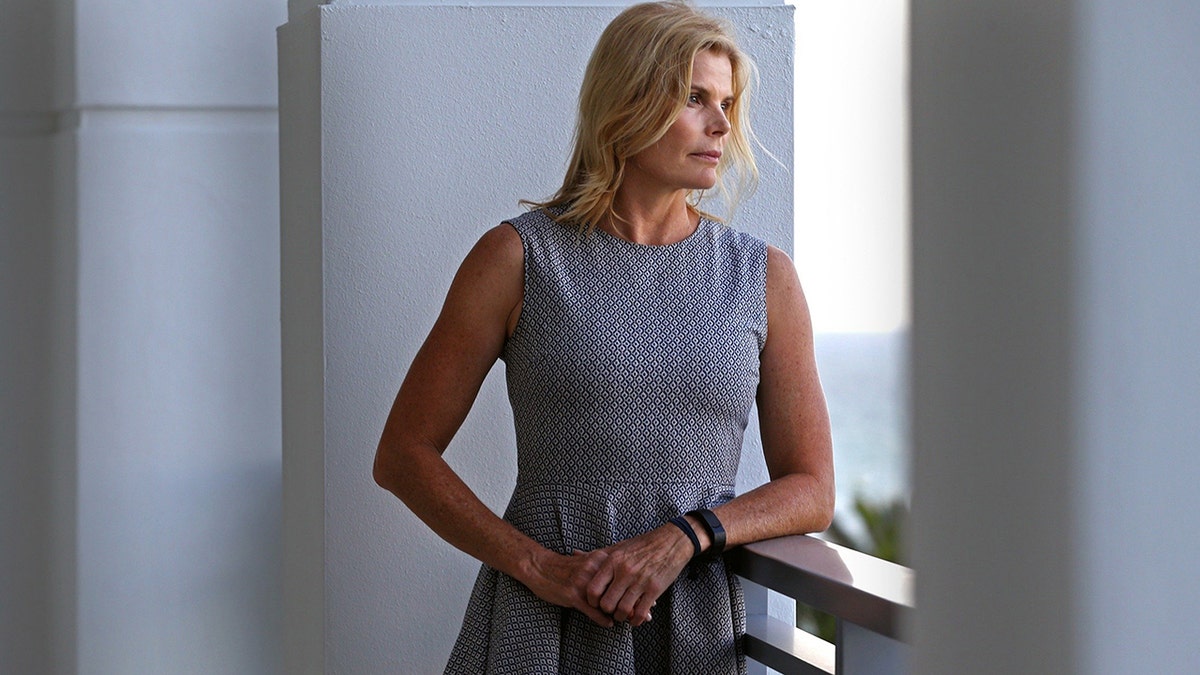 Mariel Hemingway wearing a grey sleeveless dress