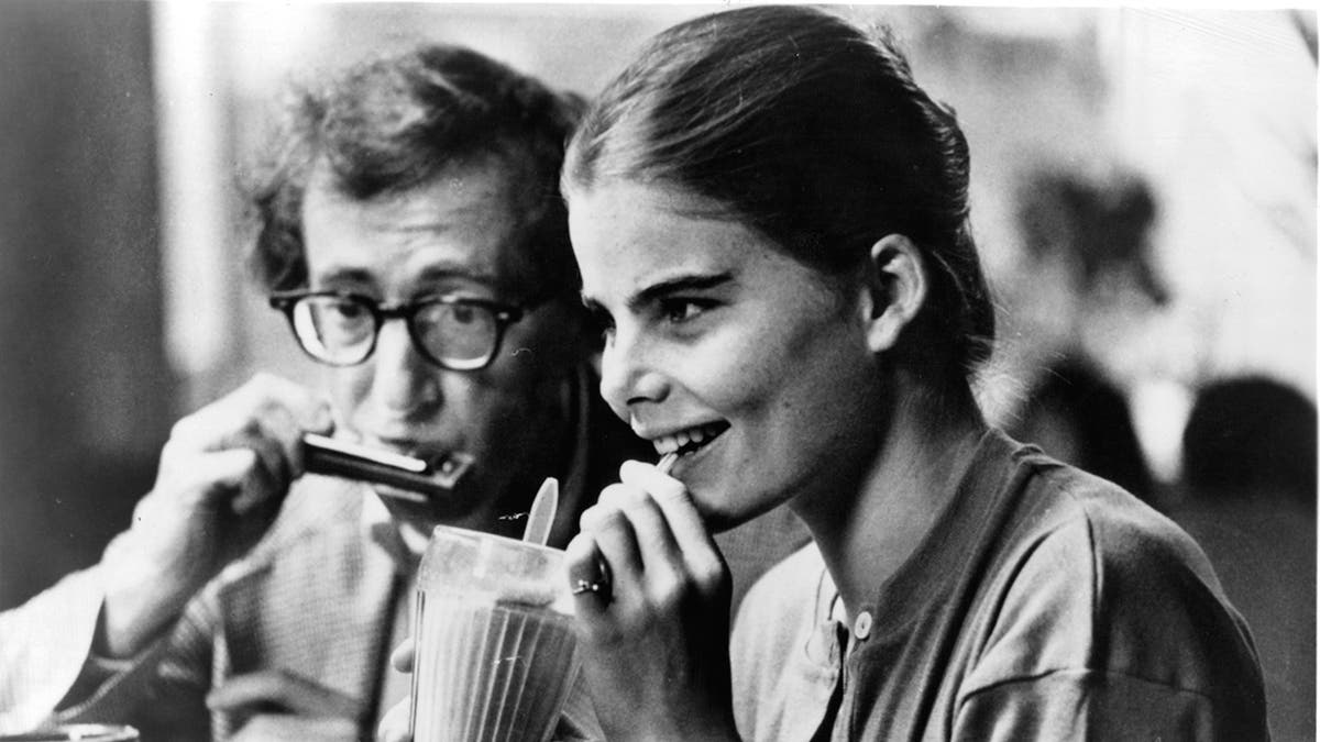 Mariel Hemingway drinking a milkshake next to Woody Allen