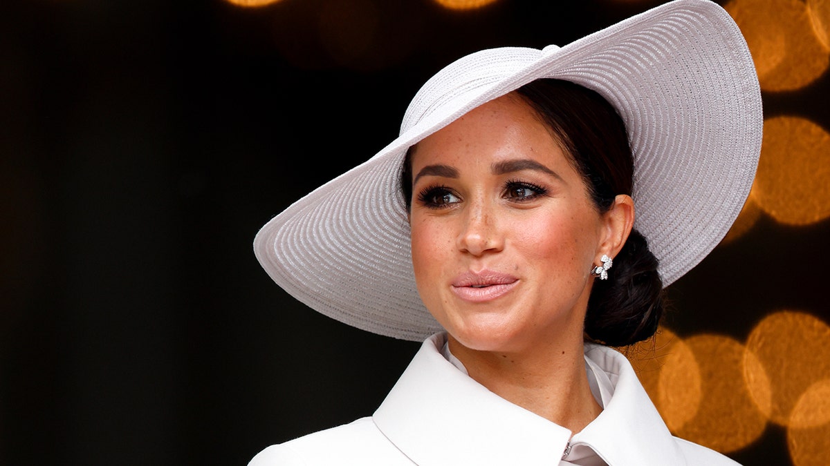 A close-up of Meghan Markle wearing white dior