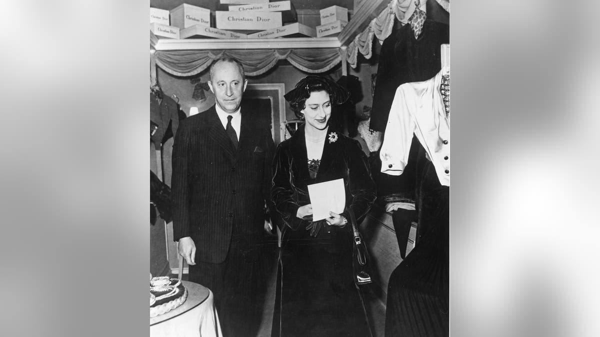 A black and white photo of Christian Dior and Princess Margaret standing next to each other