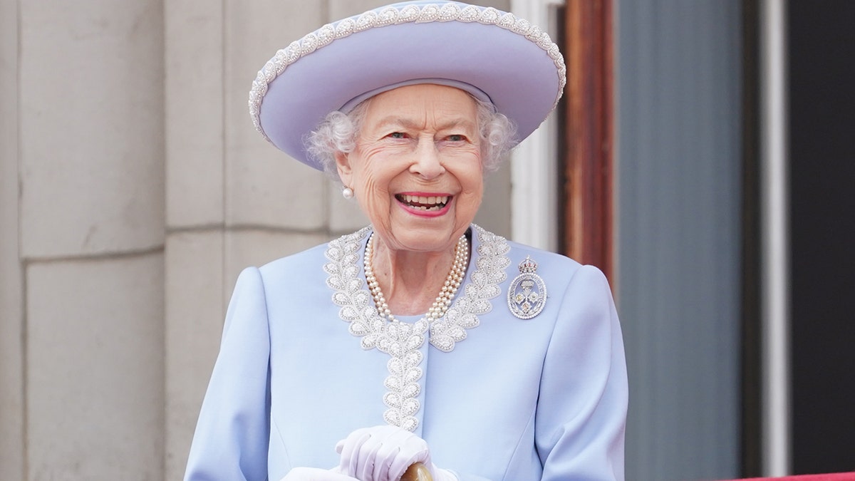 Queen Elizabeth wearing a powder blue dress and pearls