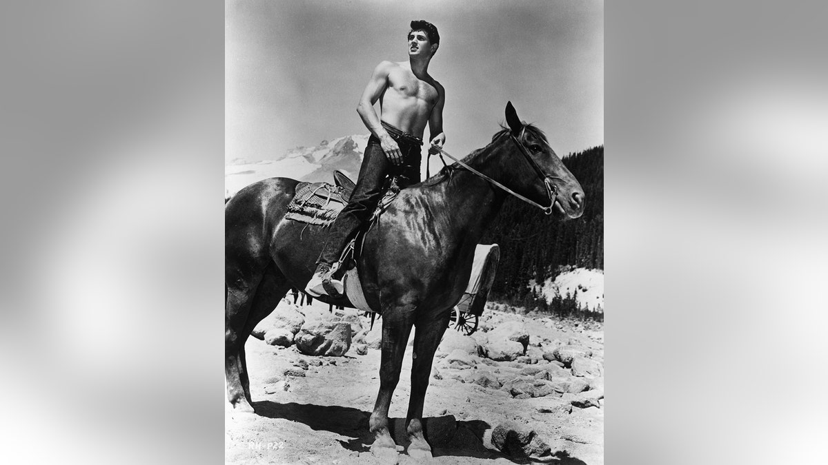Rock Hudson shirtless on a horse