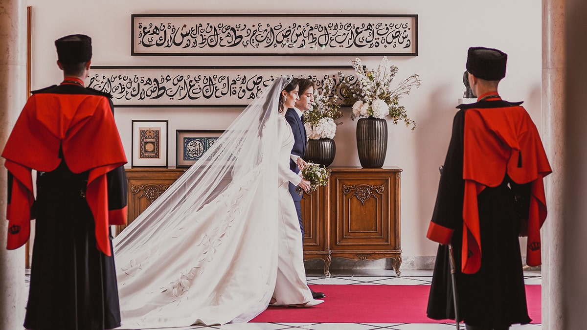 Royal family of Jordan walking to the side on their wedding day