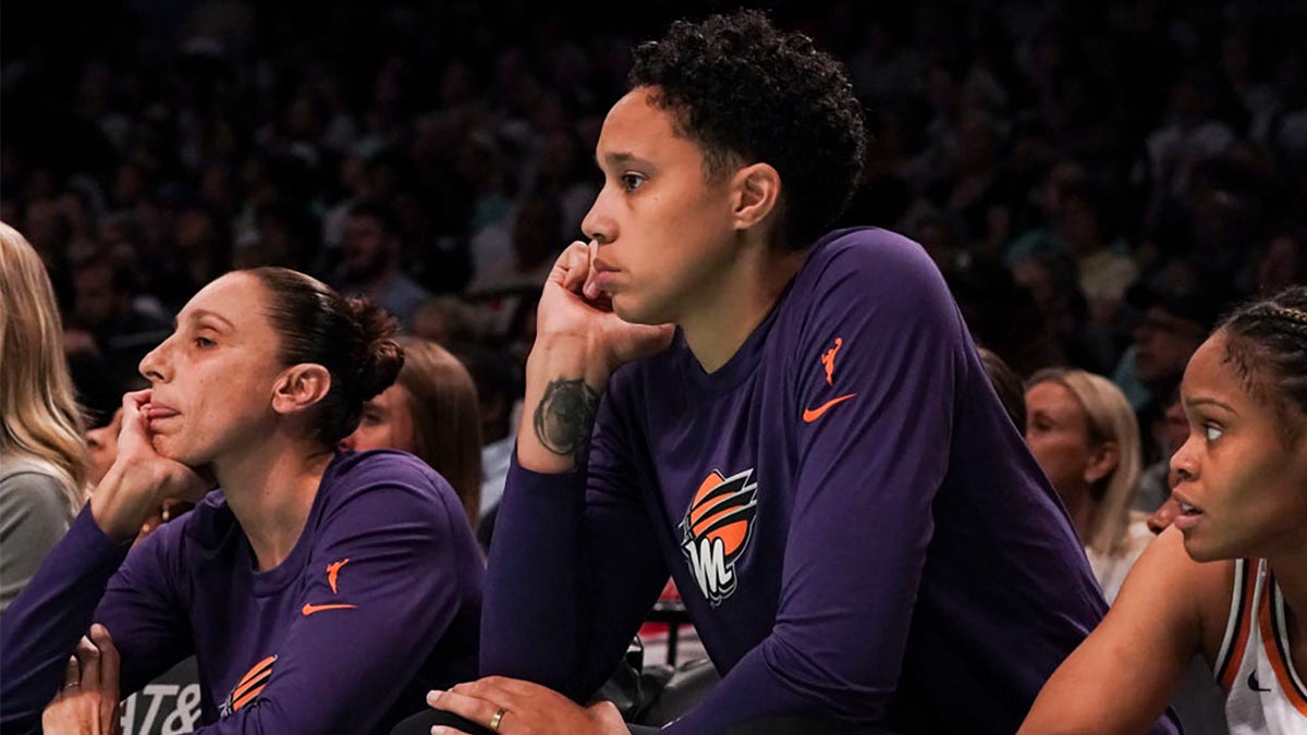 Brittney Griner with Diana Taurasi sit on bench