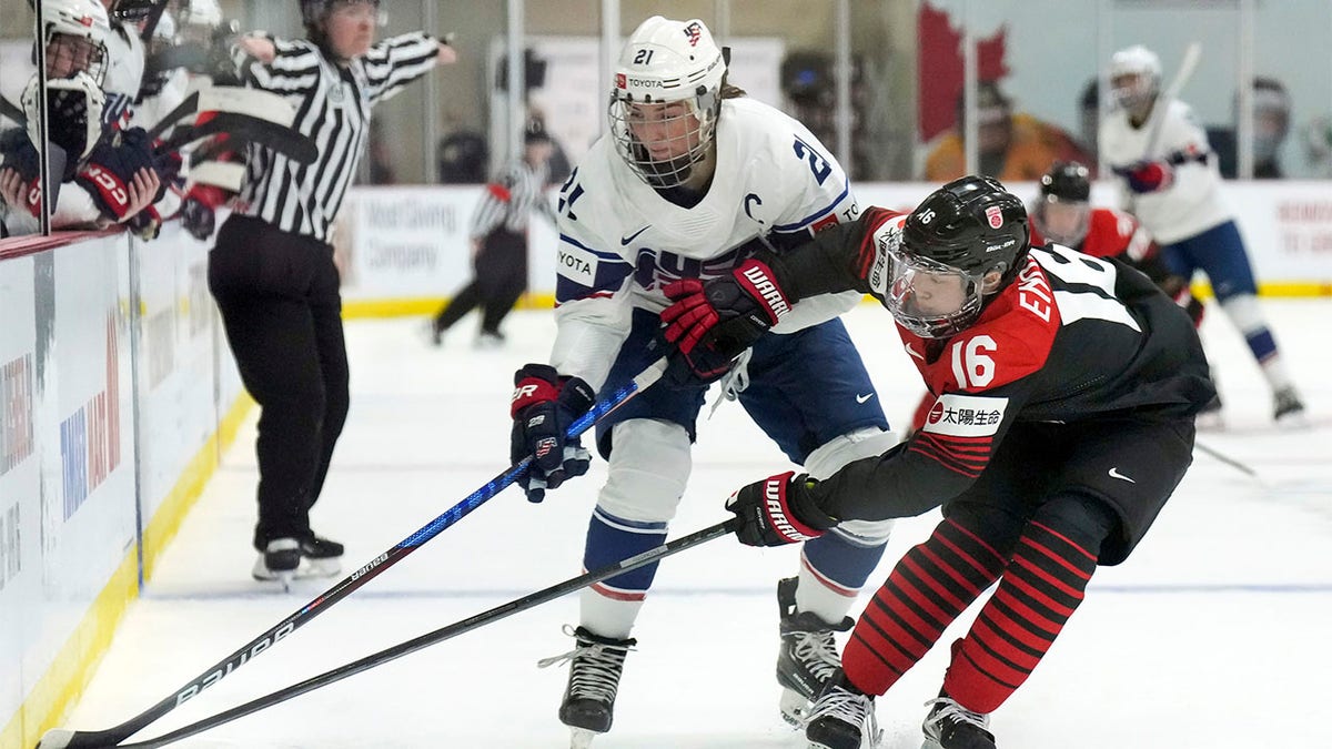 Hilary Knight battles for puck with Yoshino Enomoto