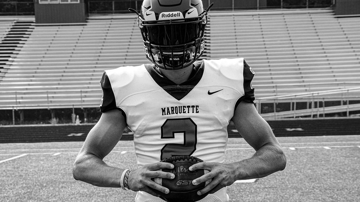 Jordan Demme holding a football