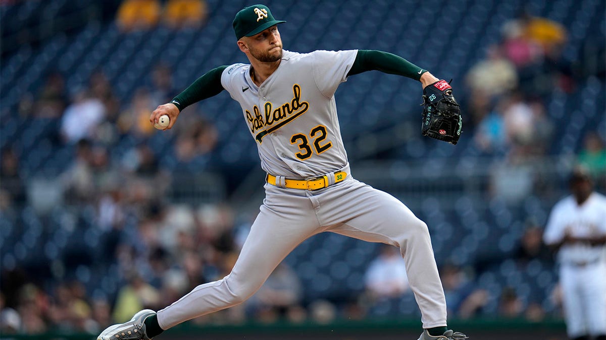 Oakland Athletics third baseman Jace Peterson, left, chases down a grounder  as Athletics shortstop Aledmys Diaz, right, looks on during the first  inning of a spring training baseball game against the San