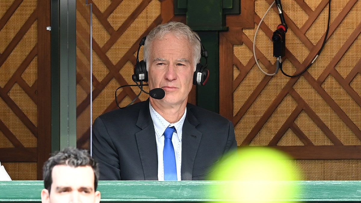 John McEnroe commentates during Wimbledon