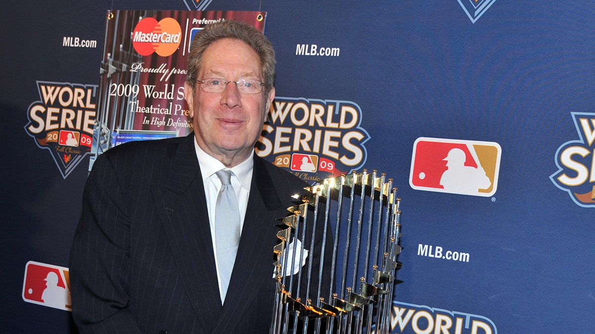 John Sterling poses with World Series trophy