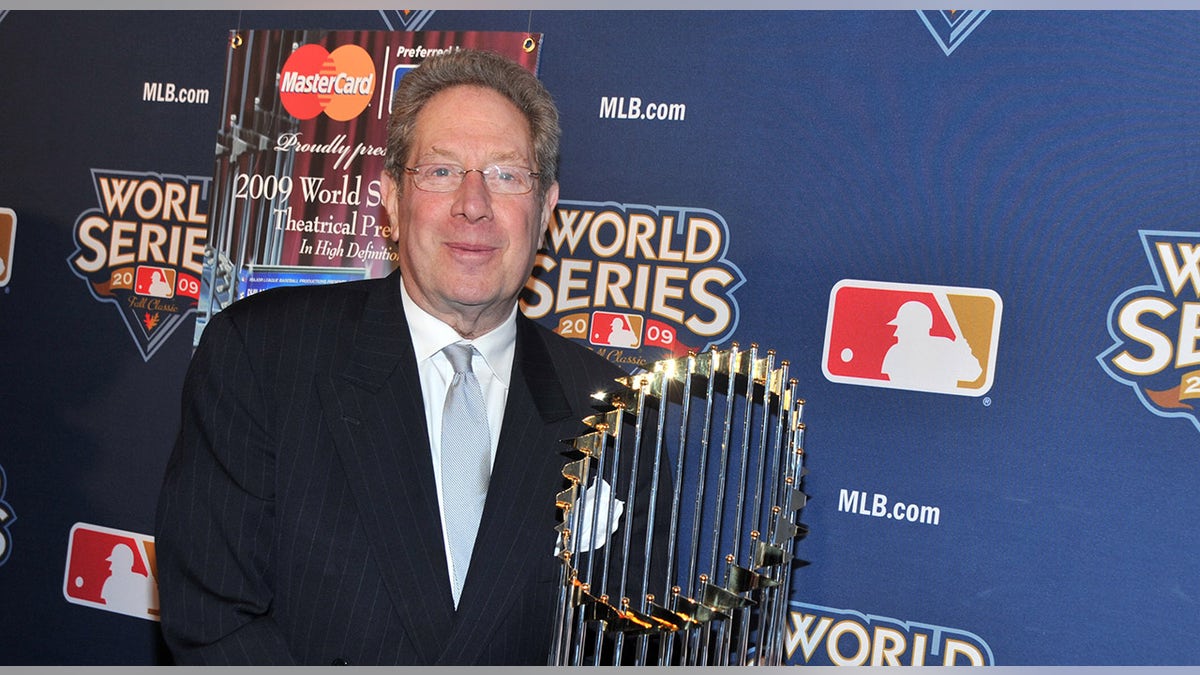 John Sterling poses with World Series trophy