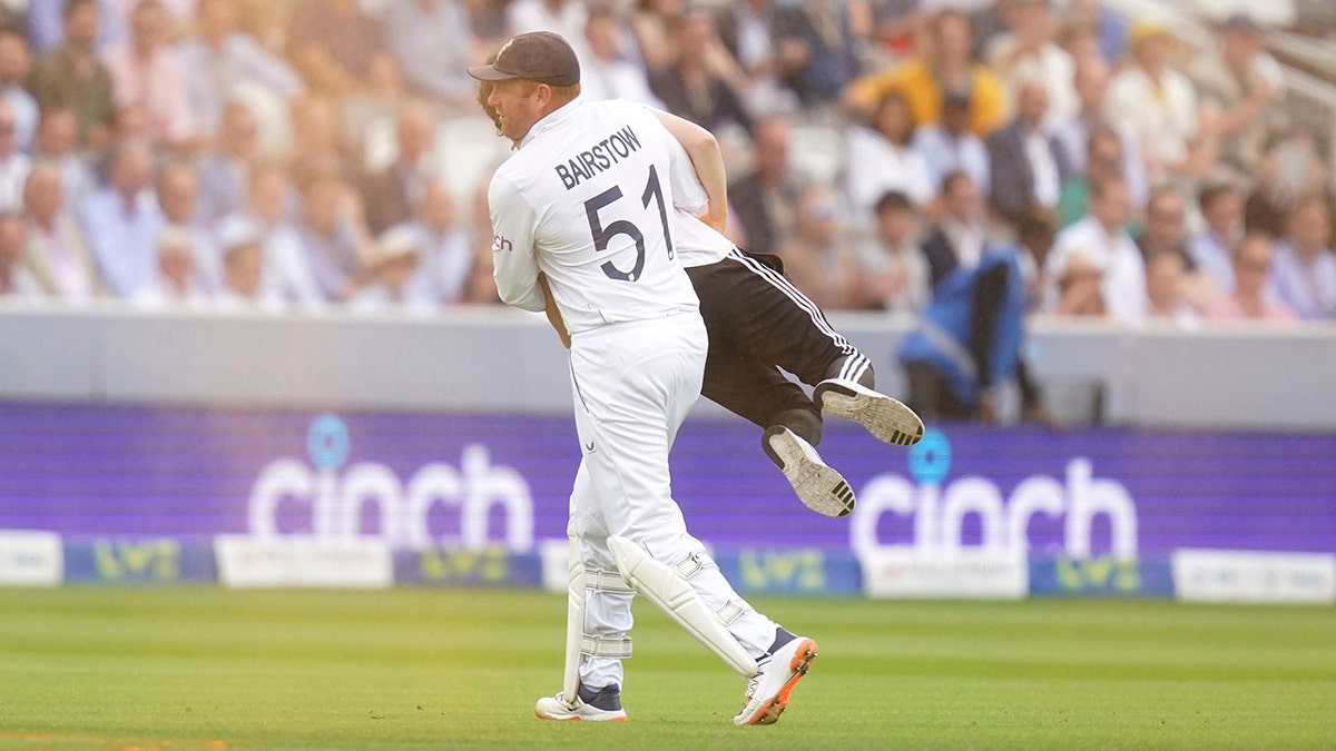 Johnny Bairstow carries a protester