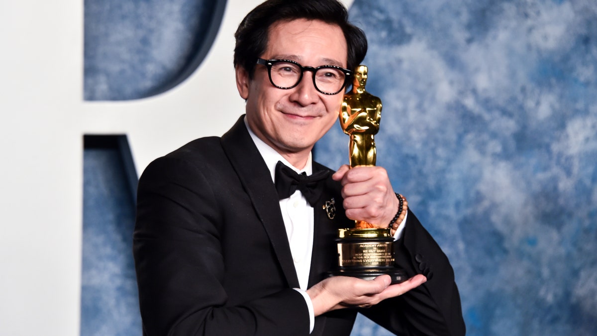 Ke Huy Quan poses with his Oscar