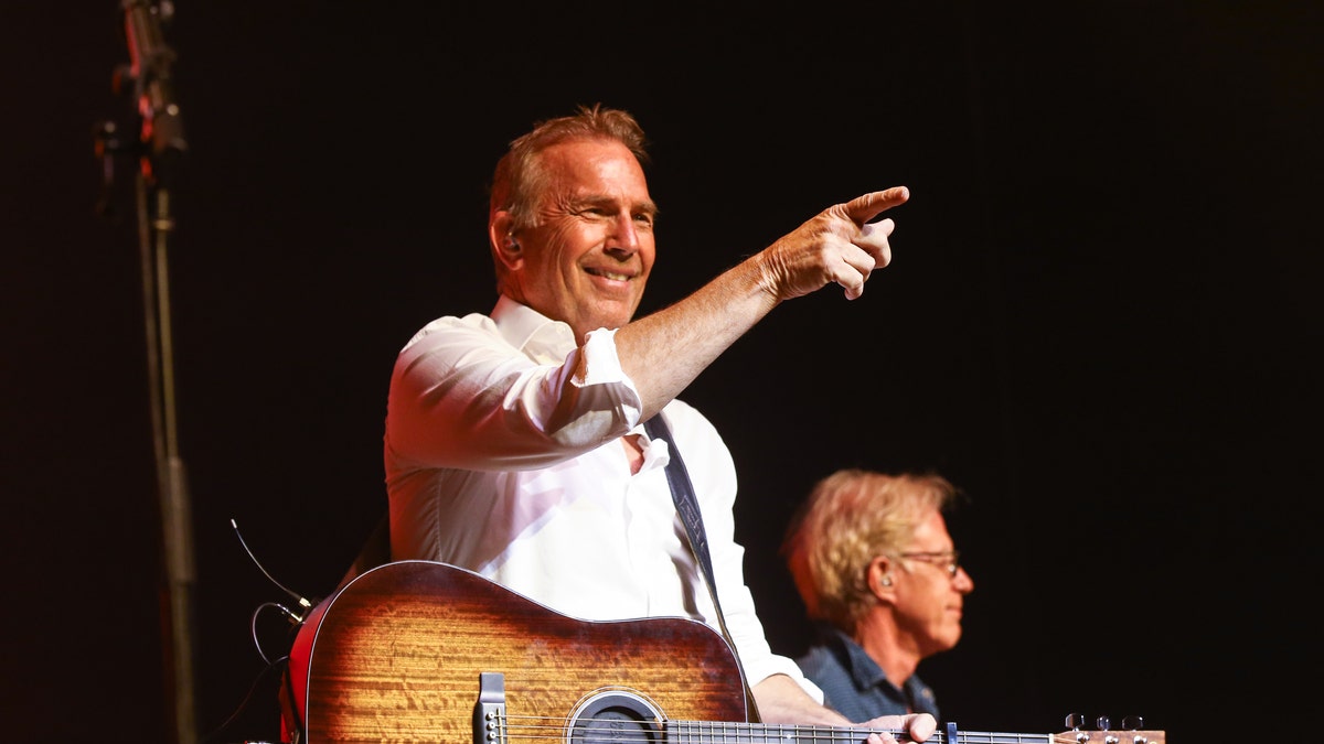 Kevin Costner on stage with his band Modern West