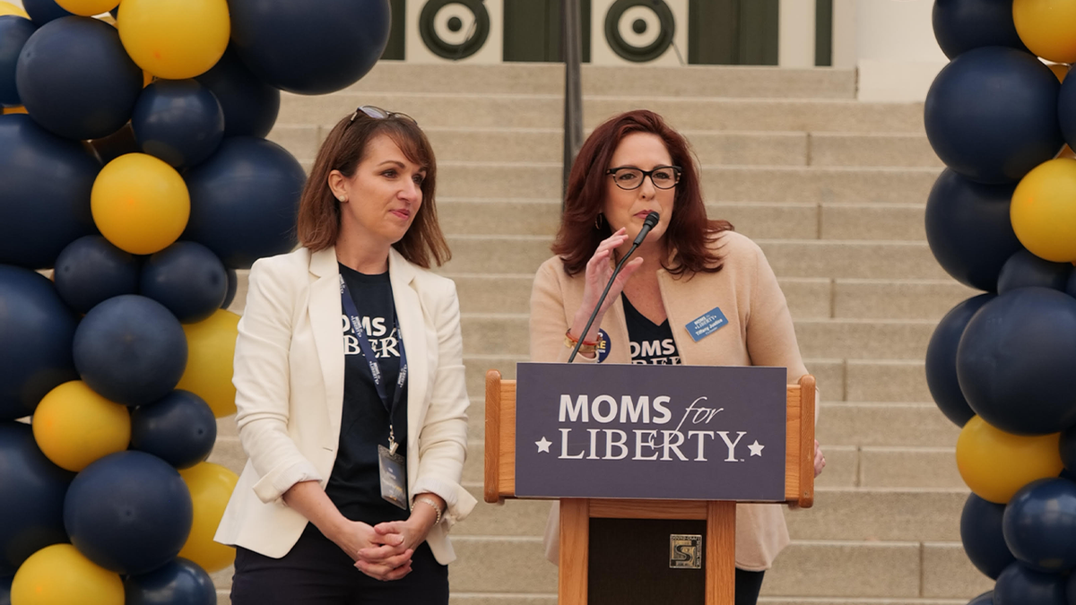 Moms for Liberty founders speak at podium
