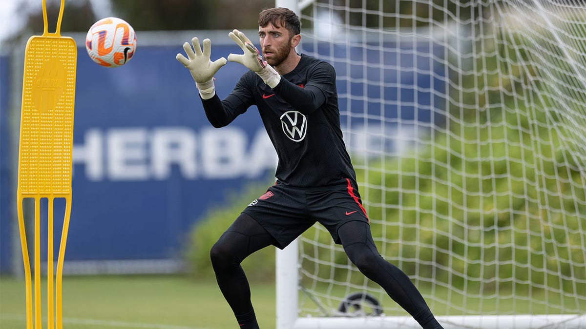 Matt Turner makes a save at practice