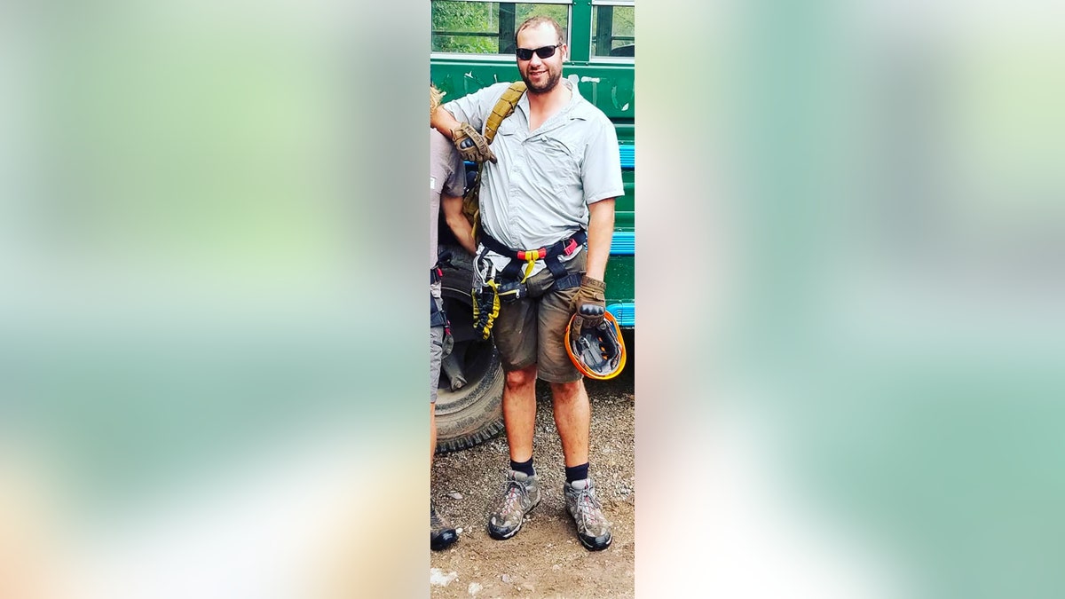 Kevin Metzger in sunglasses, holding climbing gear