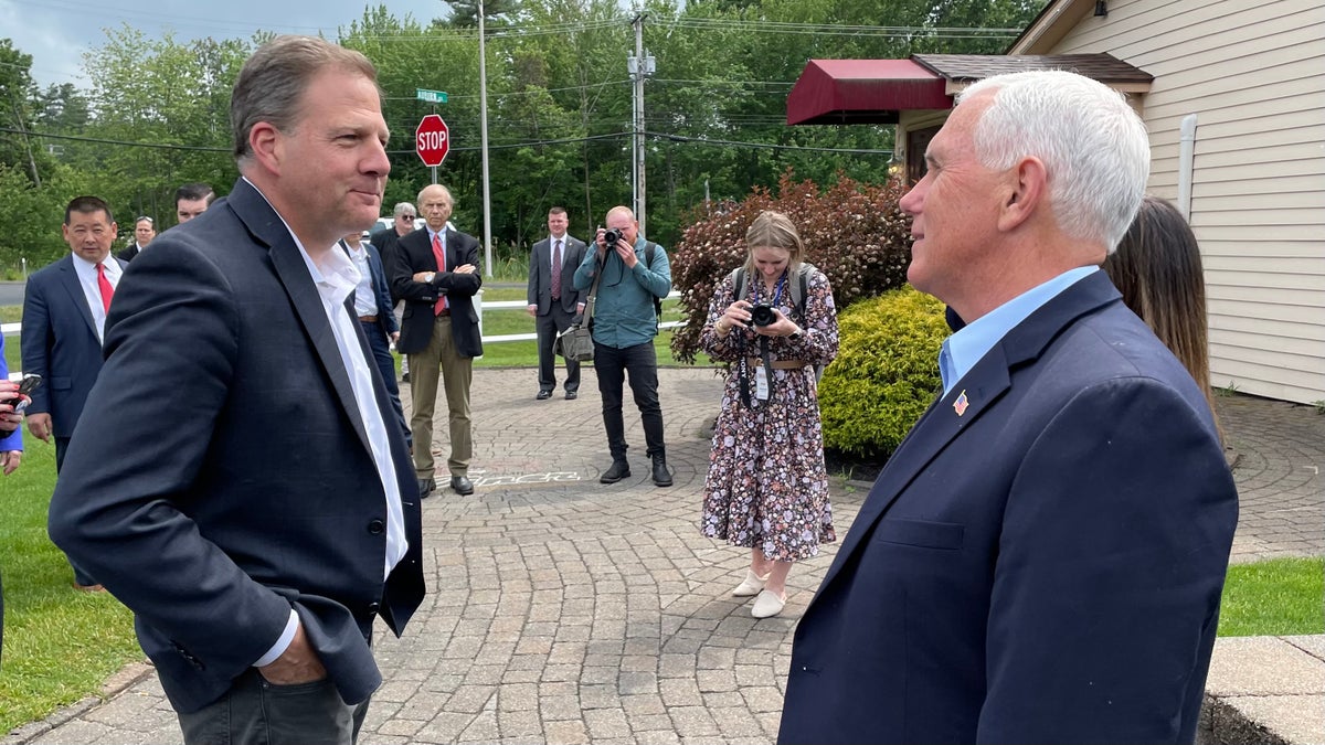 Chris Sununu and Mike Pence huddle in New Hampshire