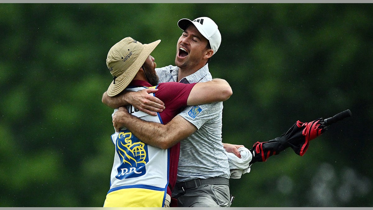 Nick Taylor celebrates with caddie