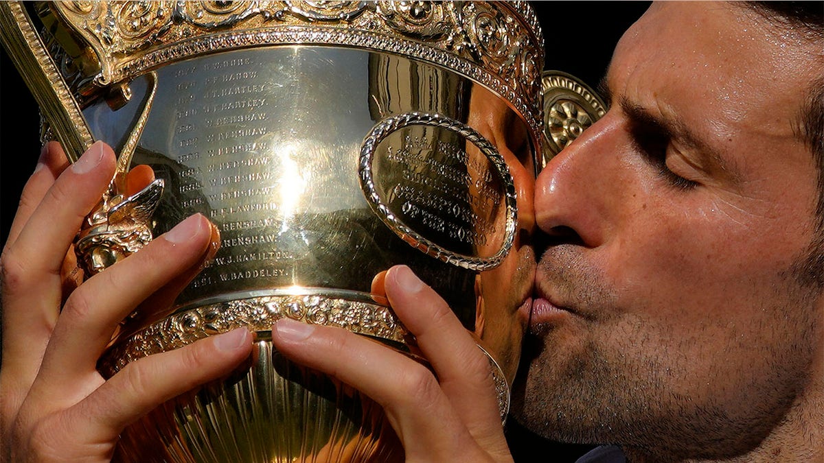 Novak Djokovic kisses trophy