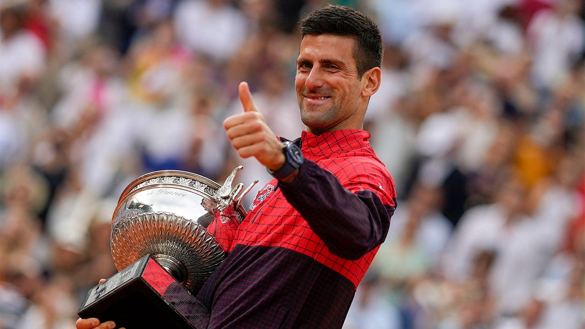 Novak Djokovic celebrates with trophy