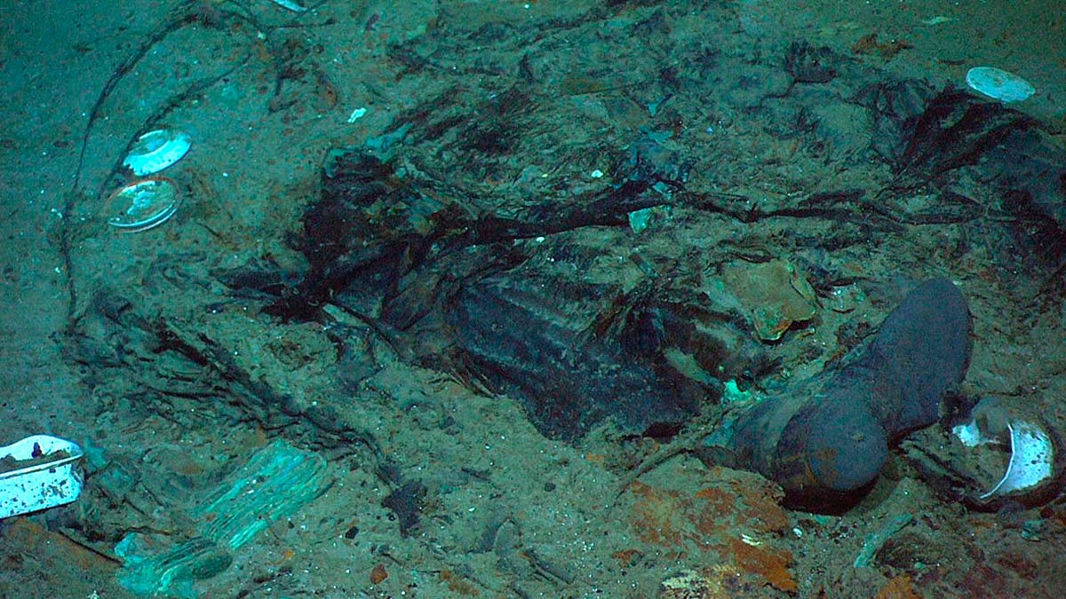 Remains of a coat and boots in the mud on the sea bed near the Titanic's stern