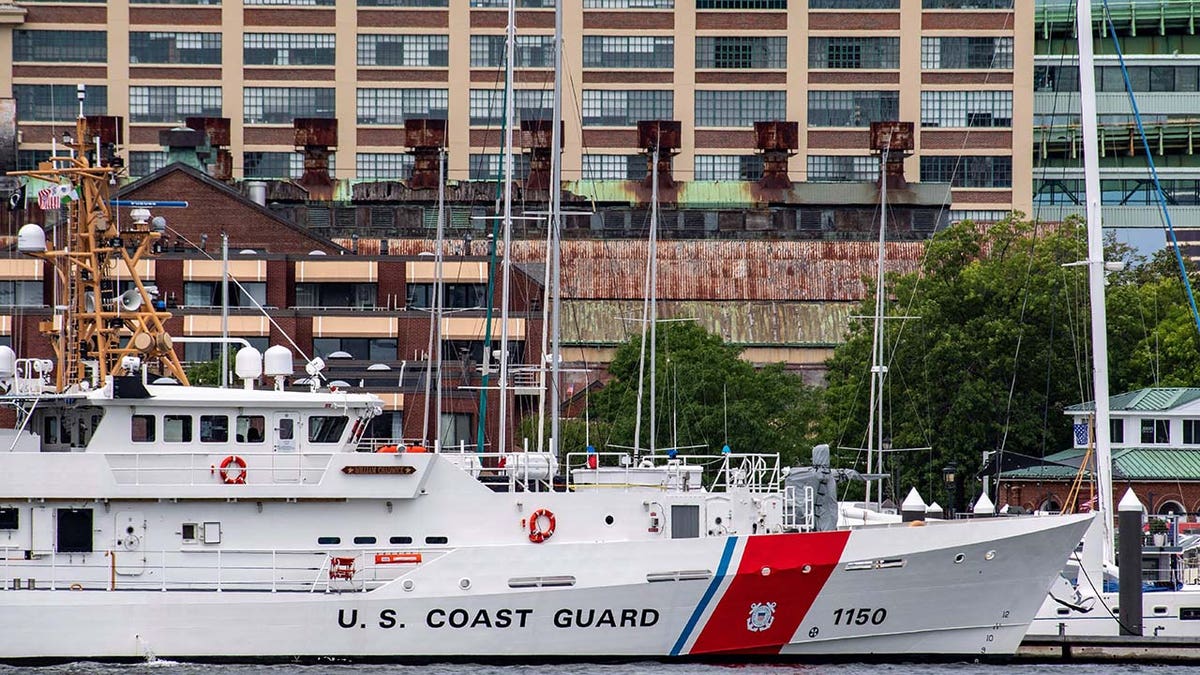 Two US Coast Guard vessels sit in port in Boston Harbor across from the US Coast Guard Station Boston in Boston, Massachusetts