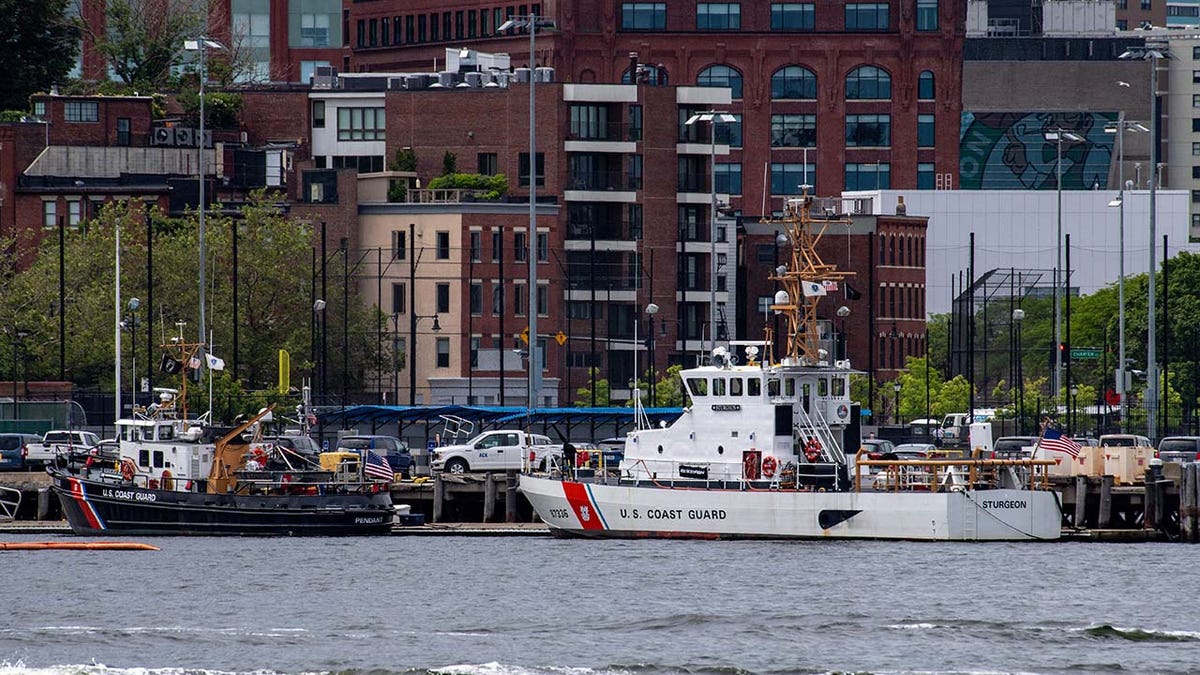 Two US Coast Guard vessels sit in port in Boston Harbor across from the US Coast Guard Station Boston in Boston, Massachusetts