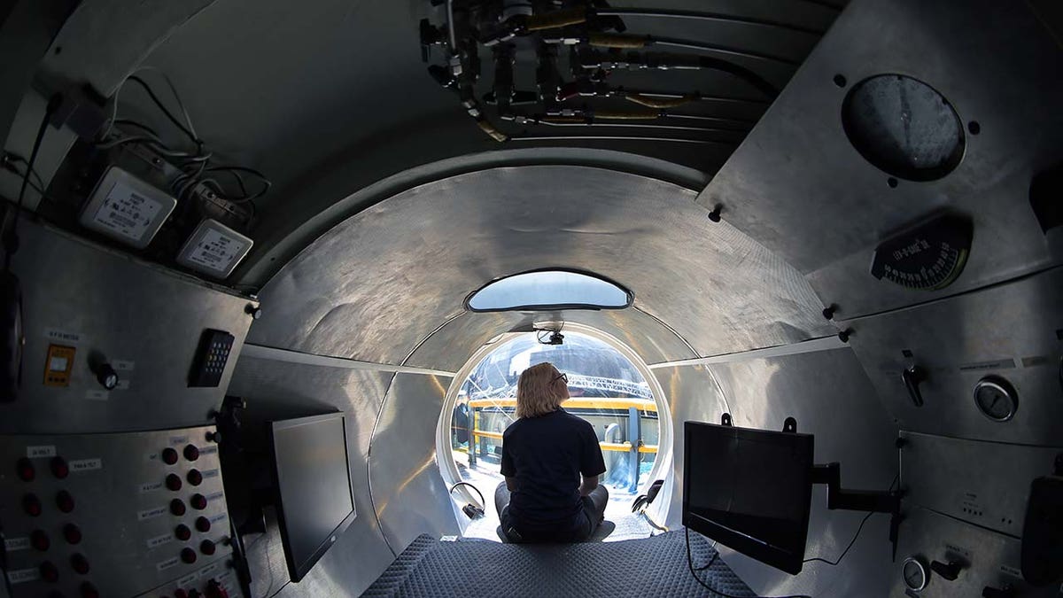 A woman sits inside an OceanGate submersible