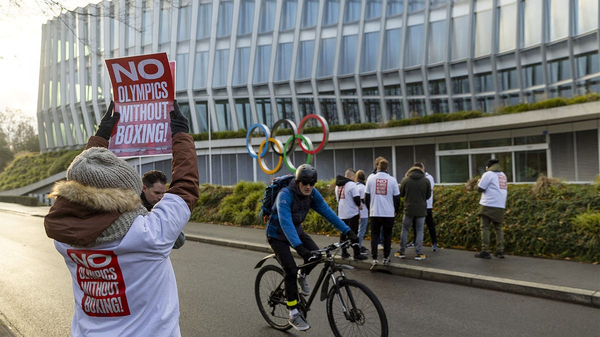 A woman holds poster in support of boxing