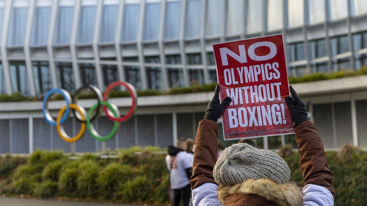 Woman holds poster in support of boxing 