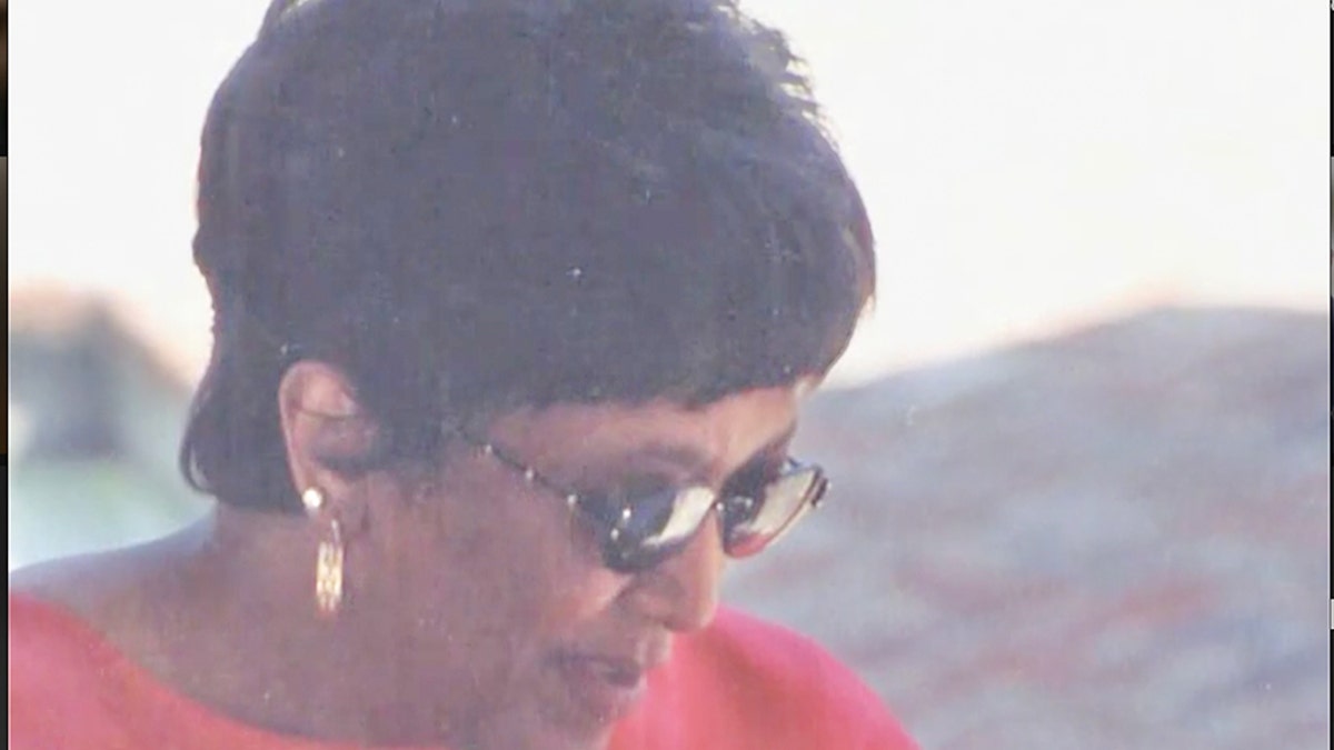 Minnie Smith wearing sunglasses and a coral blouse