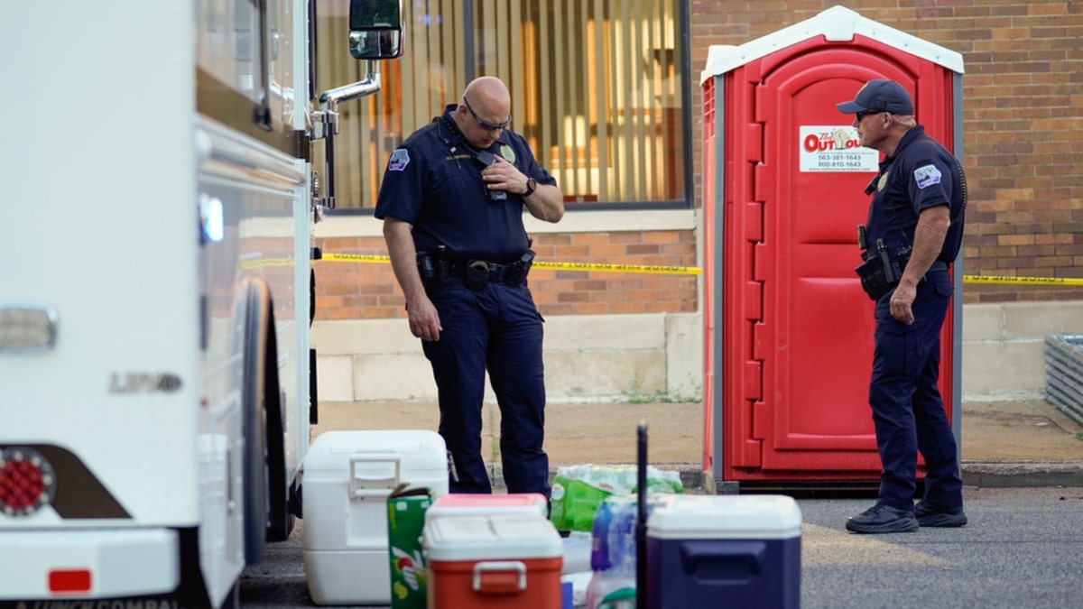 Police officers stand at the scene