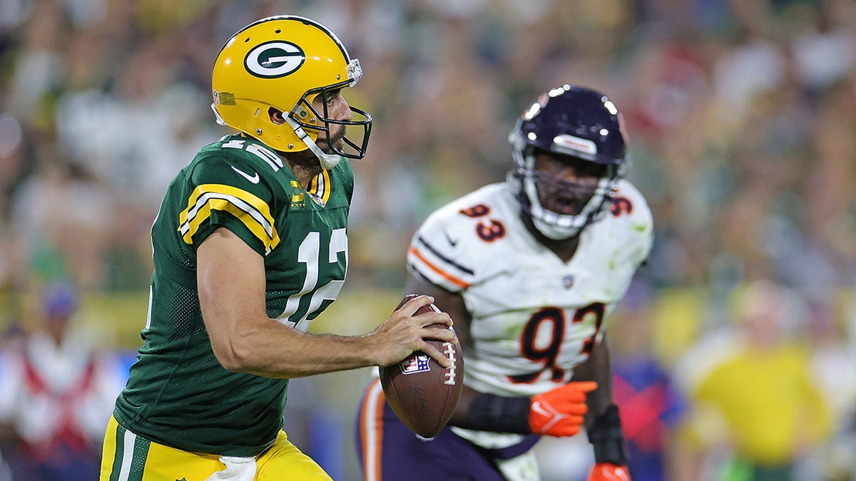 Aaron Rodgers is pursued by Justin Jones