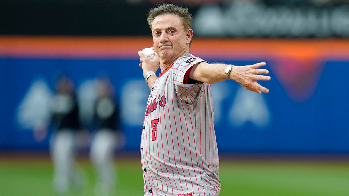 Rick Pitino throws first pitch