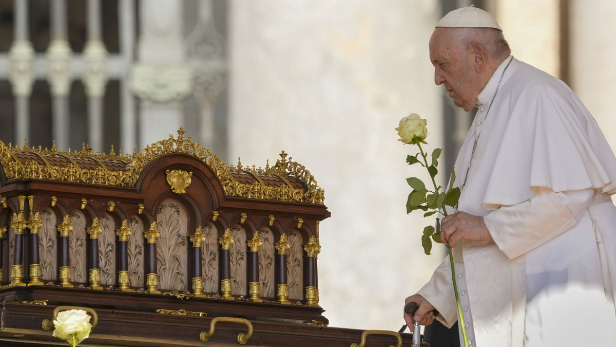 Pope Francis prays in front of relics at Vatican