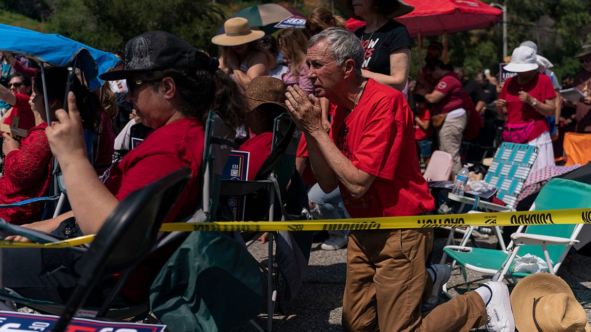 People attend a prayer service outside Dodger Stadium