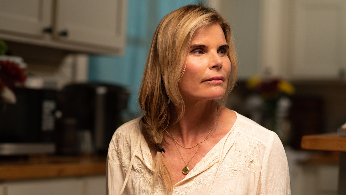 A close-up of Mariel Hemingway wearing a white blouse