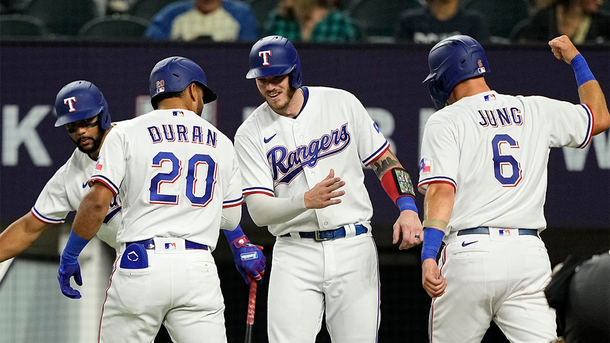 Ezequiel Duran celebrates with Leody Taveras and Josh Jung