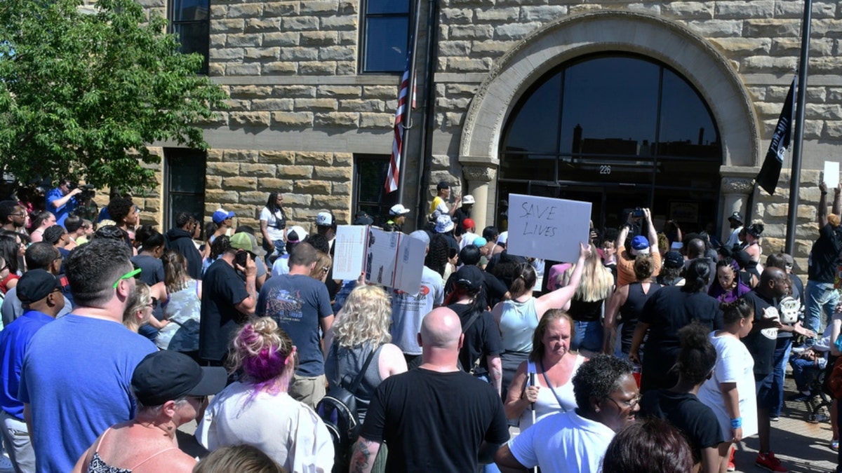 Protesters stand outside of Davenport City hall