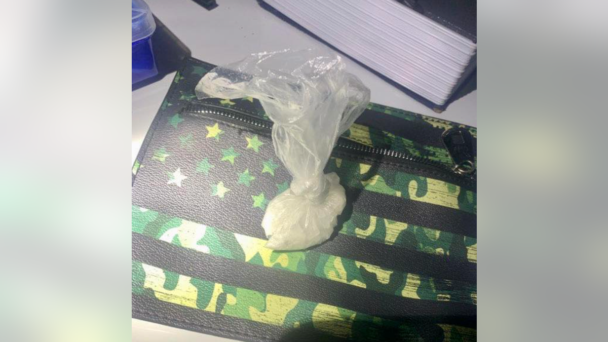 Meth bag on top of camo-colored US flag design bag