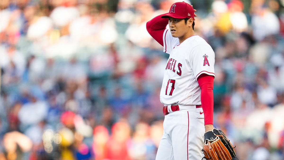 Shohei Ohtani reacts after throwing pitch