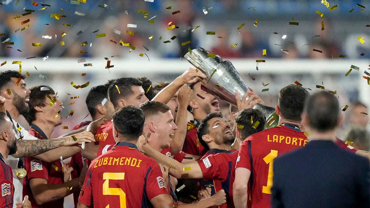 Spain players celebrate with trophy