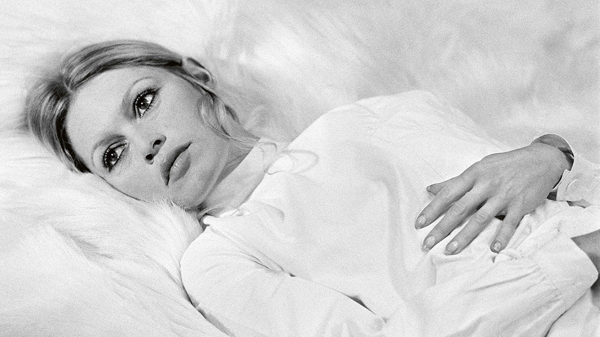 Brigitte Bardot in bed wearing white