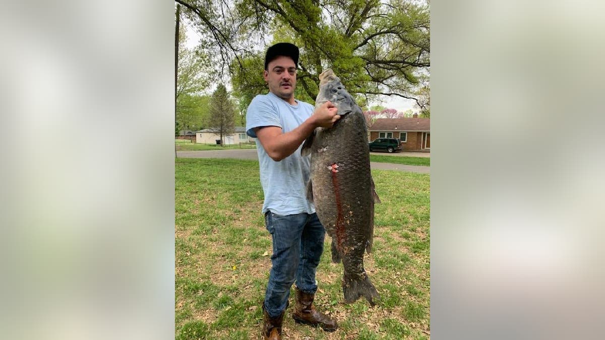 Thayne Miller holds up his record-breaking smallmouth buffalo.