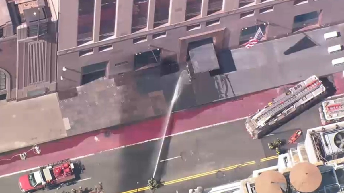 First responders dousing the Tiffany building where smoke was seen.