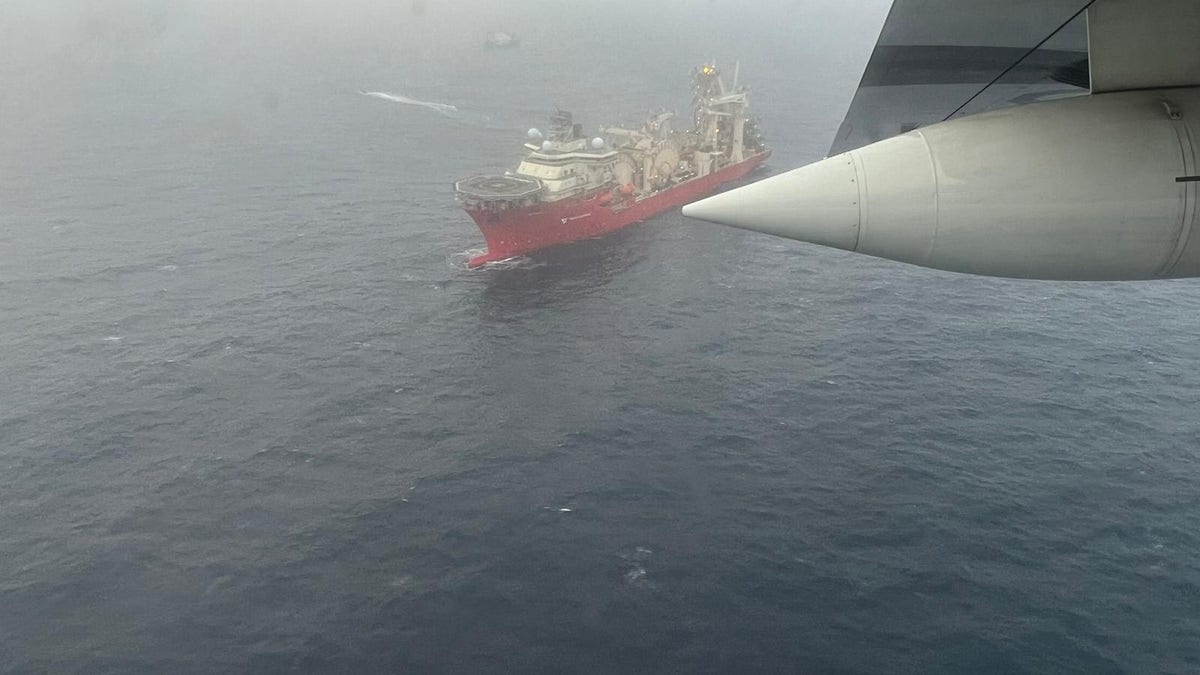 Aerial photo from a USCG plane showing a search vessel at sea