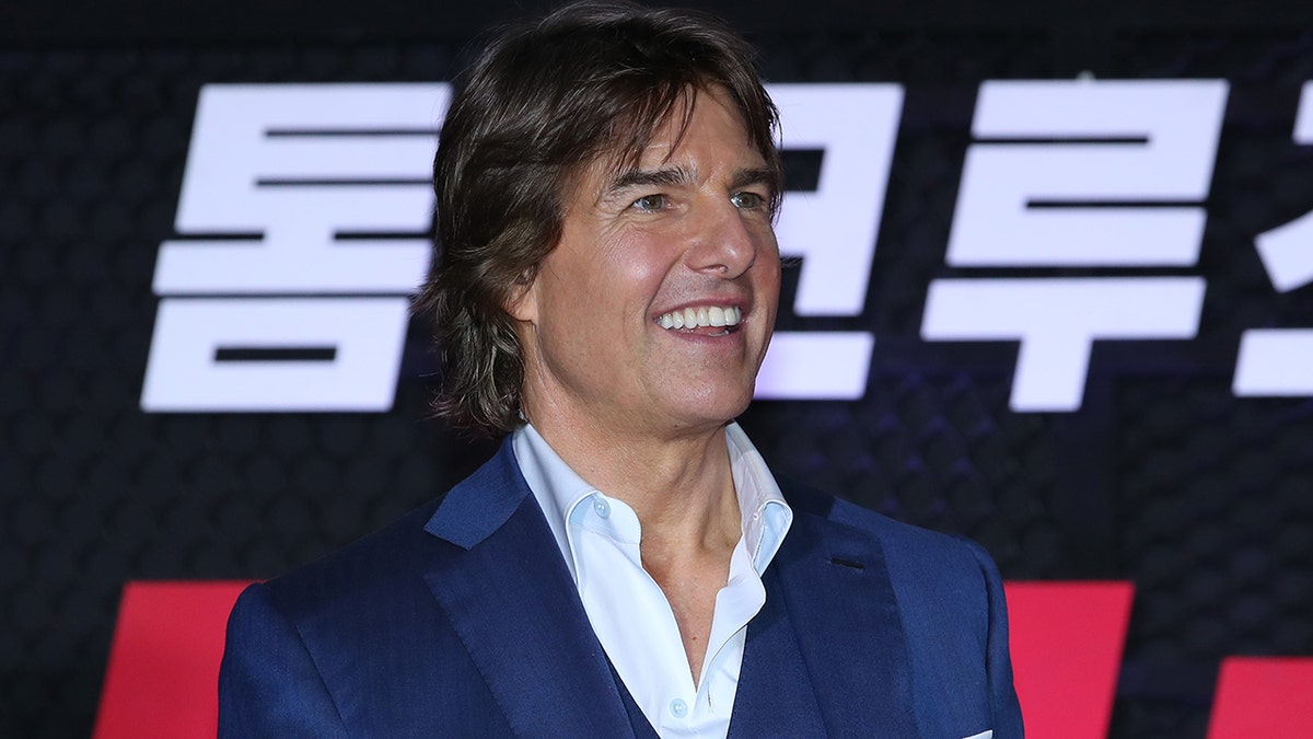 Tom Cruise smiling at a movie premiere