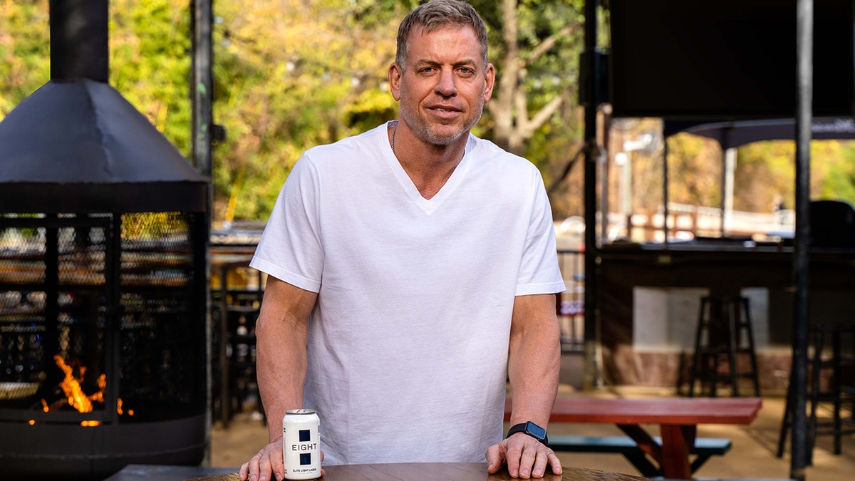 Troy Aikman holds a beer