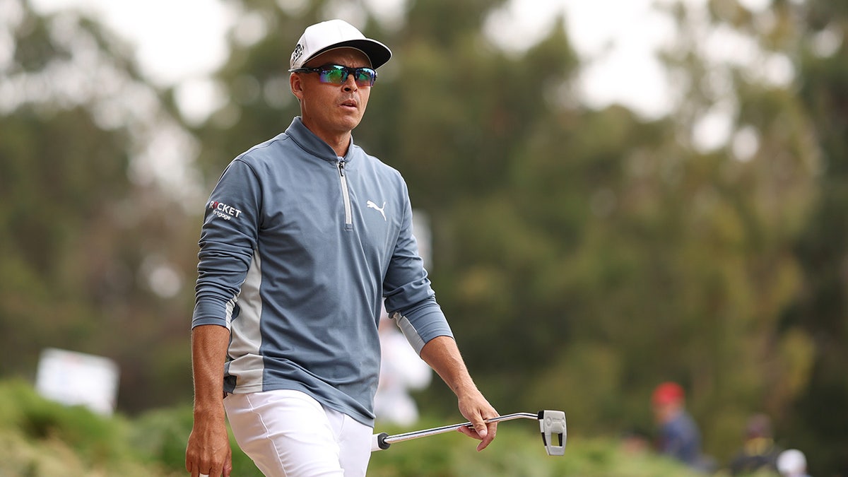 Rickie Fowler walks from the seventh tee