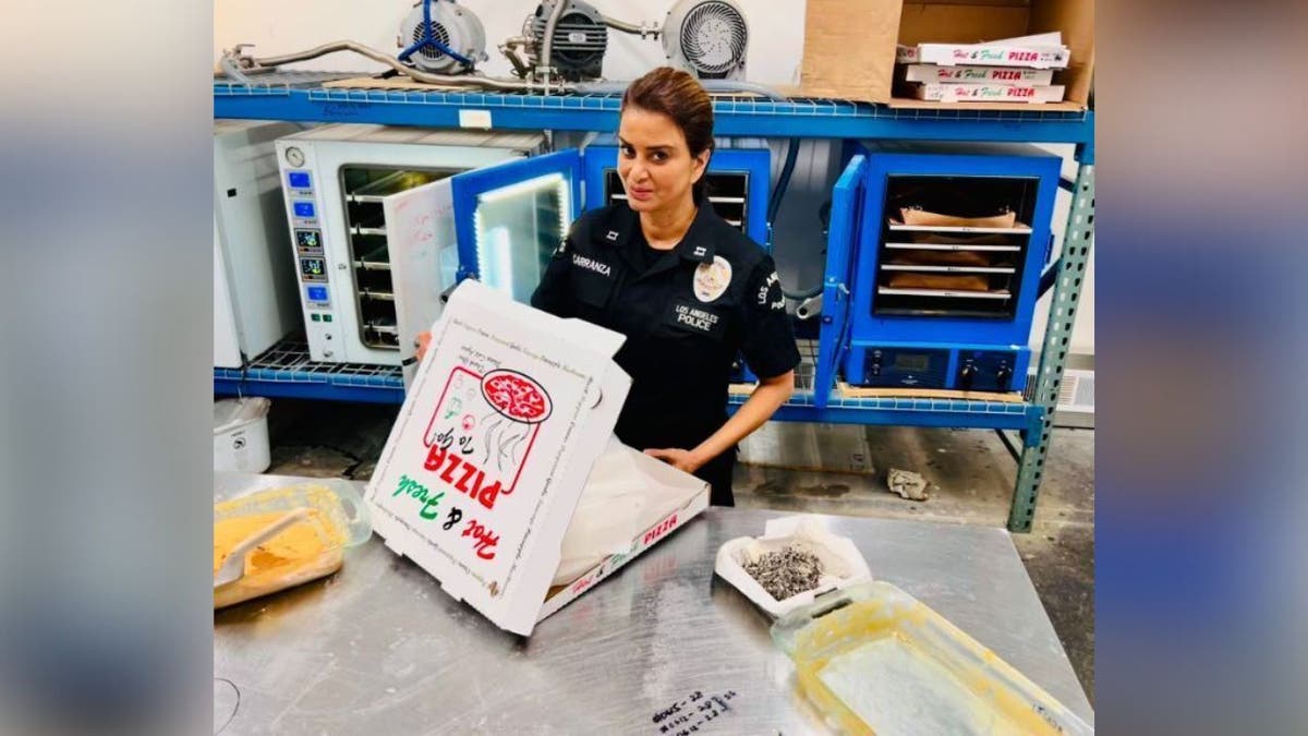 LAPD officer with pizza box